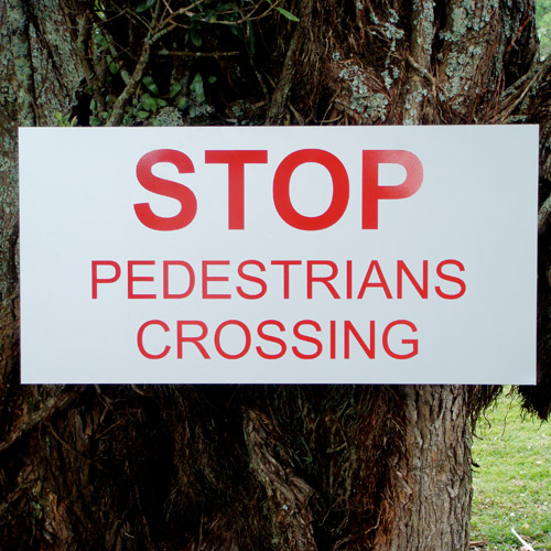 Confusing stop pedestrians crossing sign